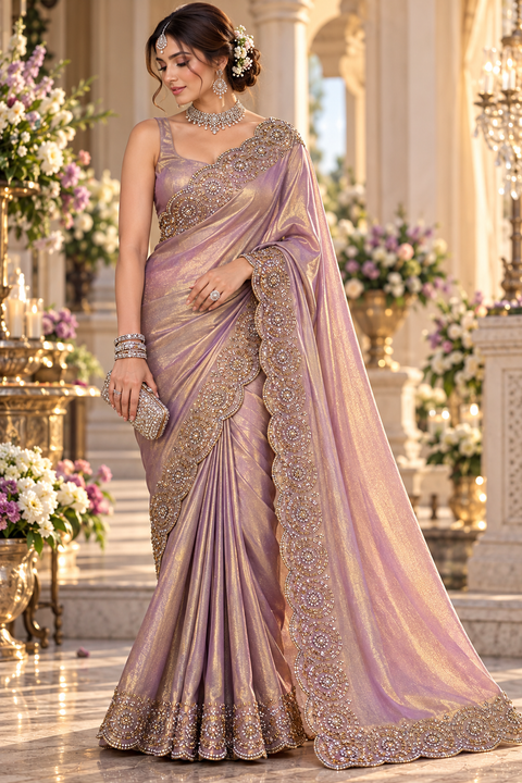 Two-Tone Tissue Silk Saree with a beautiful gold sheen and elegant handcrafted border detailing. Comes with an attached blouse piece; blouse worn by the model is for reference only. Slight variation in colour and design is possible.