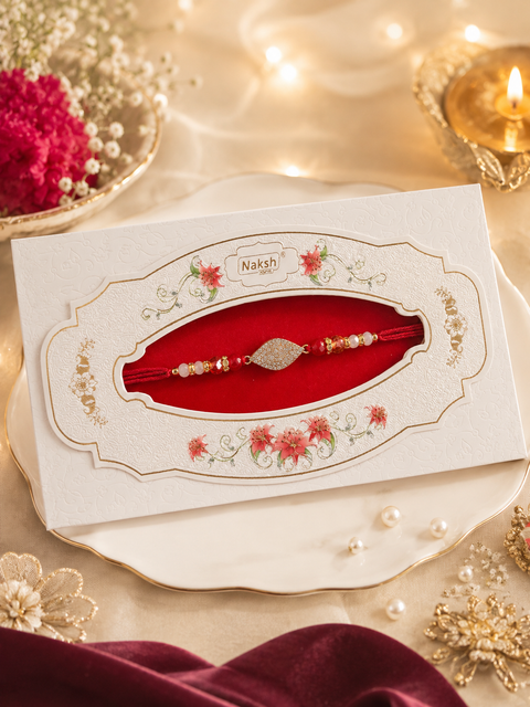 American Diamond Stylish stone designer Rakhi with pearl detailing, presented in a premium gift box