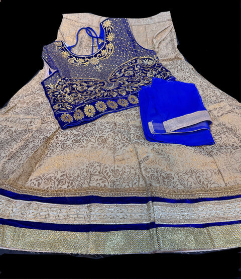 Royal blue colour velvet based blouse with embroidery & Stone work with golden brocade silk Lehnga & netting dupatta