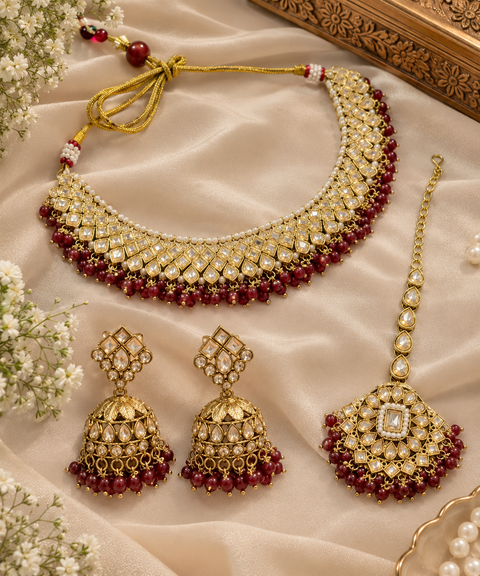 Elegant polki Necklace Set featuring beautiful Kundan stones, pearl detailing and bead drops. Comes with matching earrings and maang tikka. Slight variation in colour and design may be possible.