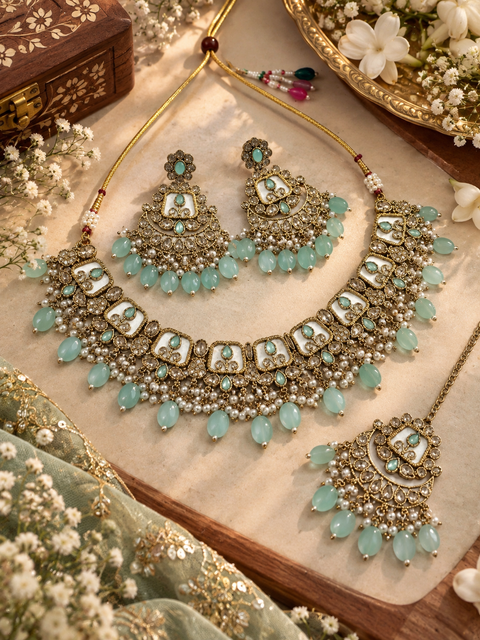 Beautiful polki stones with pearls and colorful stones necklace & earrings with Tikka. Slight variations in colour and design are possible