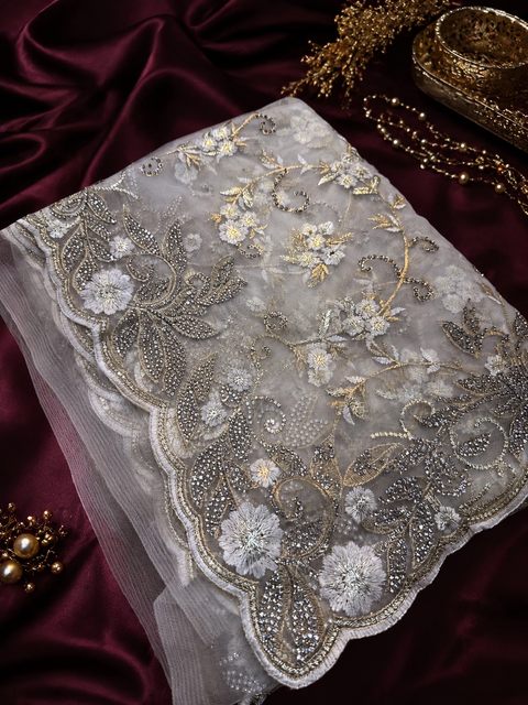 Heavy work designer Saree with netting base fabric and stones work design all over with heavy embroidery work.The Blouse Worn By The Model Is For Reference Purposes Only. The Actual Blouse Piece Comes Attached With Saree(Slight Variations Are Possible)