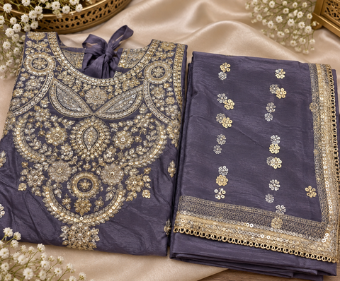 Elegant Chanderi Silk suit featuring all-over heavy embroidery and mirror work with a beautifully detailed neckline. Paired with a heavily embroidered palazzo and a gorgeous matching dupatta .Slight variation may ofcolour & design is possible