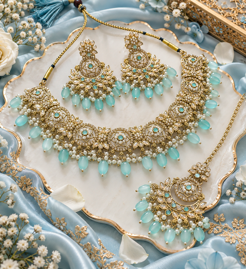Beautiful polki stones with pearls and colorful stones necklace & earrings with Tikka. Slight variations in colour and design are possible