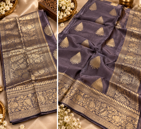 Luxuriously soft silk saree with a smooth, lightweight feel and beautifully flowy drape. Featuring rich woven zari floral motifs and an elegant detailed border .Blouse piece included. Slight variation in colour and design is possible.