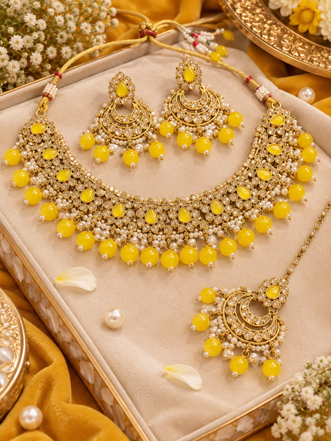 Beautiful polki stones with pearls and colorful stones necklace & earrings with Tikka. Slight variations in colour and design are possible