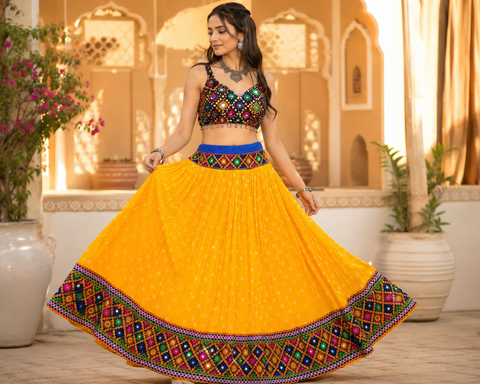 Yellow Bandhani flared Chaniya skirt with colourful mirror work borders—perfect for festive wear. Blouse not included.