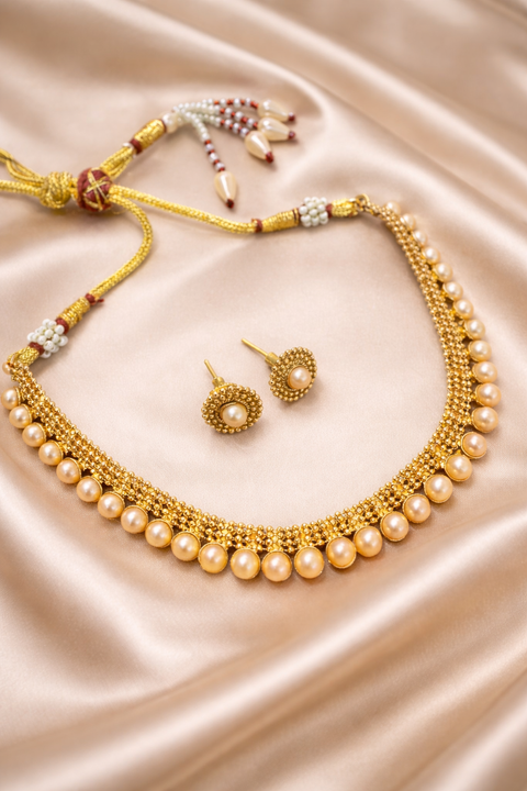 Golden traditional necklace set with pearls work and small studs