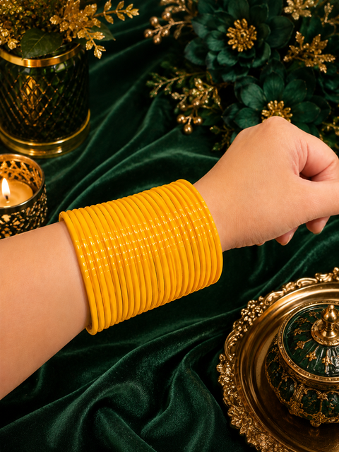 Yellow color plain gloss glass bangles. Each set includes 2 dozen bangles. Price is per set. Slight colour variation may occur