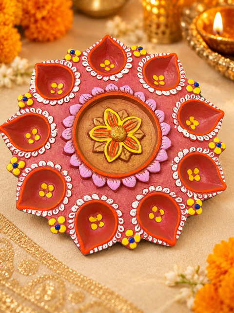 Handcrafted and hand-painted clay diya stand, perfect for Diwali décor and puja. Slight variations in colour, design and texture may occur, with minor natural surface lines due to the handmade clay finish.