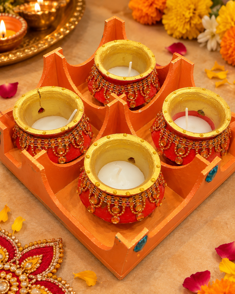Handcrafted 4-Piece Diwali Candle Diya Set with wax-filled decorative pots, finished with beautiful gold and stone detailing. Perfect for festive décor and gifting. Minor cracks or variations may occur due to the handmade nature of the product.