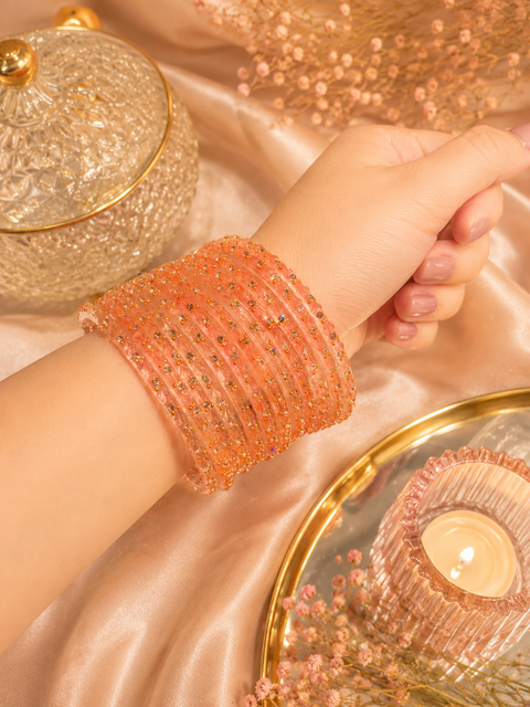 Apricot Peach Elegant Kashmiri bangles featuring a premium handcrafted design with sparkling stone and gold detailing(slight variation in color and design is possible) one dozen bangles per set (price per set)