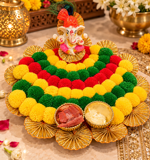 Handcrafted festive Ganesha décor with vibrant pom-poms, golden detailing and attached bowls. Kumkum and rice included. Perfect for puja, Diwali décor and gifting.
