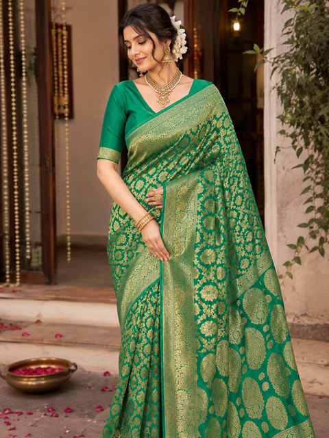 Elegant Banarasi Silk Saree with stone-work border. Blouse worn by the model is for reference only; saree comes with its own attached blouse piece. Slight variation in color and design may occur
