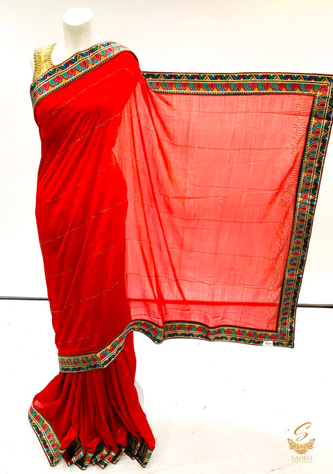 Red colour soft crape silk based embroidered broder with stone work saree