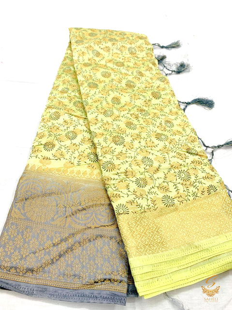 Pastel yellow colour brocade soft silk saree with grey colour pallu design and border
