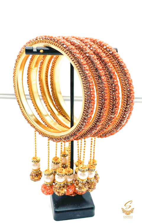 Peach and Golden Colour Fine Stones Beautiful Brass Bangles Set With Beautiful stone & pearl Work Latkans (4 Bangles Set)