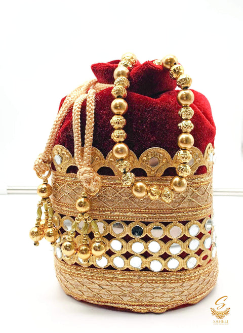 MAroon colour velvet based mirror work with pearl work handle beautiful Potli Bag